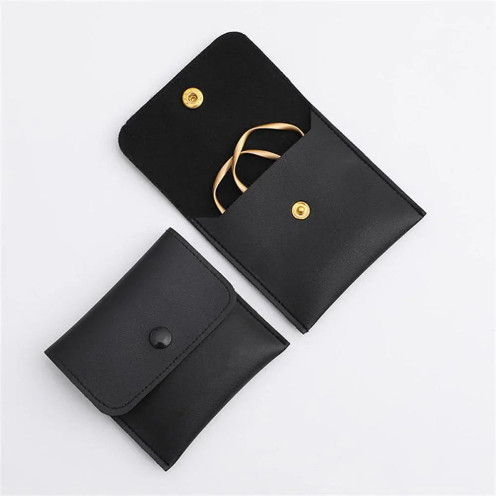 Black elegant PU leather jewelry pouch with a gold chain and snap button