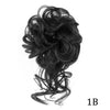 A dark black messy synthetic hairpiece bun for women