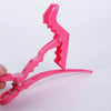 A pink professional multifunctional hair sectioning clips set is shown being held by a hand.