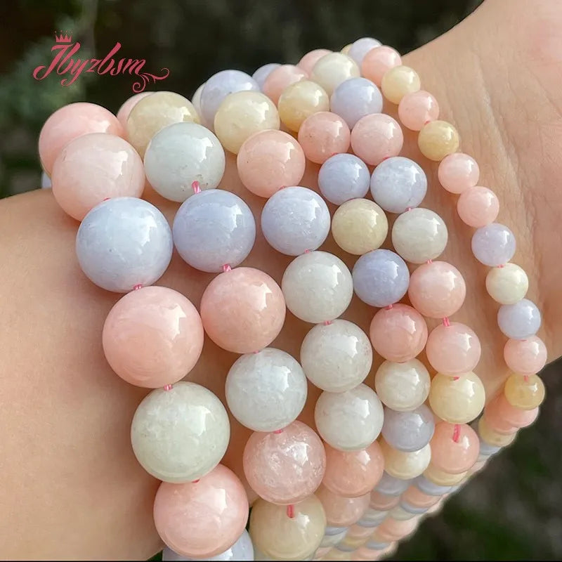 A bracelet made of smooth round jade beads in various shades of pink, white, and lavender.