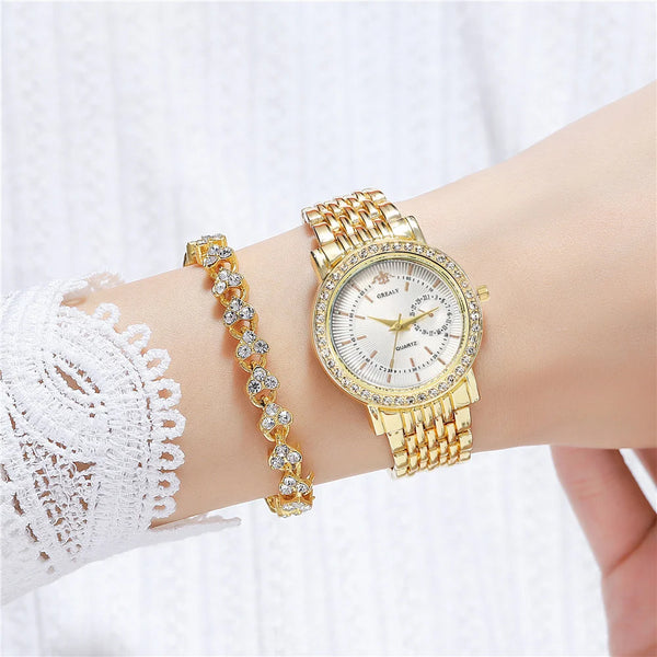 A close-up of a gold-toned crystal quartz wristwatch worn on a wrist, featuring a diamond-studded band and bracelet.