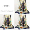 Three luxury satin silk scarves featuring intricate blue and gold floral patterns