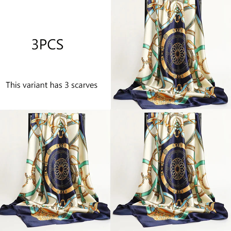 Three luxury satin silk scarves featuring intricate blue and gold floral patterns
