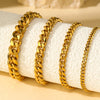 Gold stainless steel multi-chain anklets displayed on a white towel.