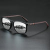 A pair of vintage square polarized cycling sunglasses with dark frames and brown accents resting on a dark surface.