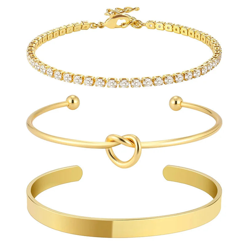 Three gold plated stainless steel bracelets for women including a chain bracelet, a bangle, and a cuff.