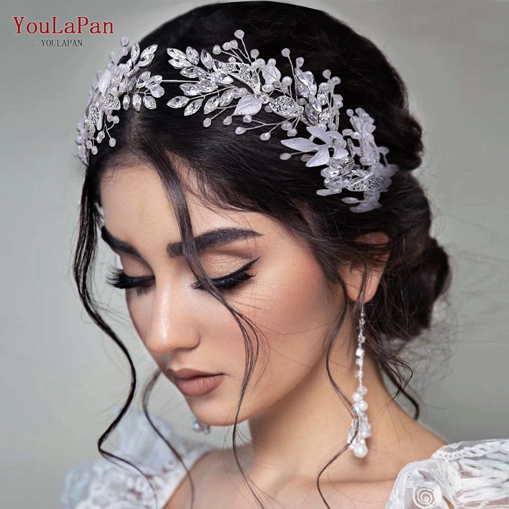 A close-up of a woman wearing a silver crystal bridal headband with floral accents.