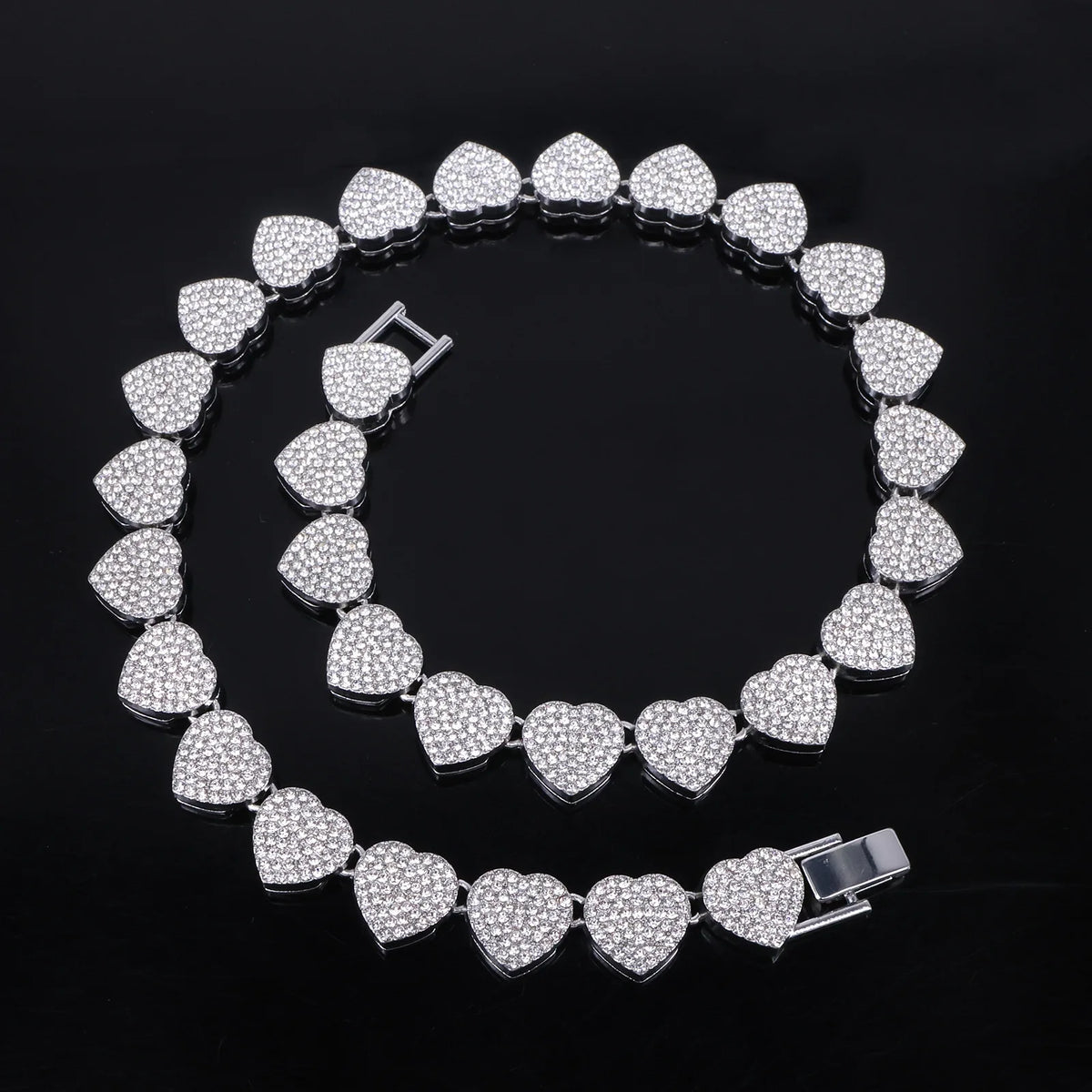 A set of sparkling heart rhinestone necklaces and bracelets displayed against a black background.