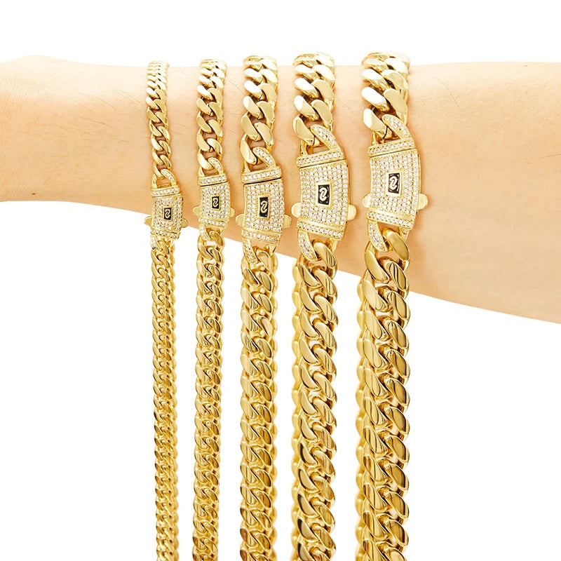 A close-up of a gold Cuban link chain necklace displayed on a wrist.
