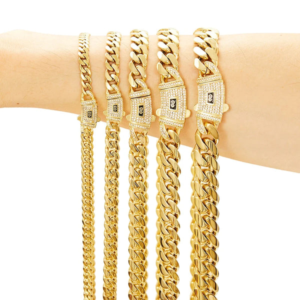 A close-up of a gold Cuban link chain necklace displayed on a wrist.