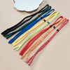 A collection of colorful adjustable eyewear lanyards and necklaces arranged diagonally on a light background.