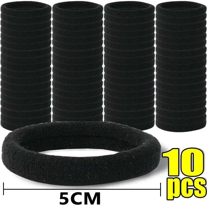 Ten black elastic hair bands stacked and one laid out, measuring 5cm wide.