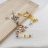 A set of ten mini hollow butterfly metal hair clips in various gold and silver finishes displayed on a wooden board.