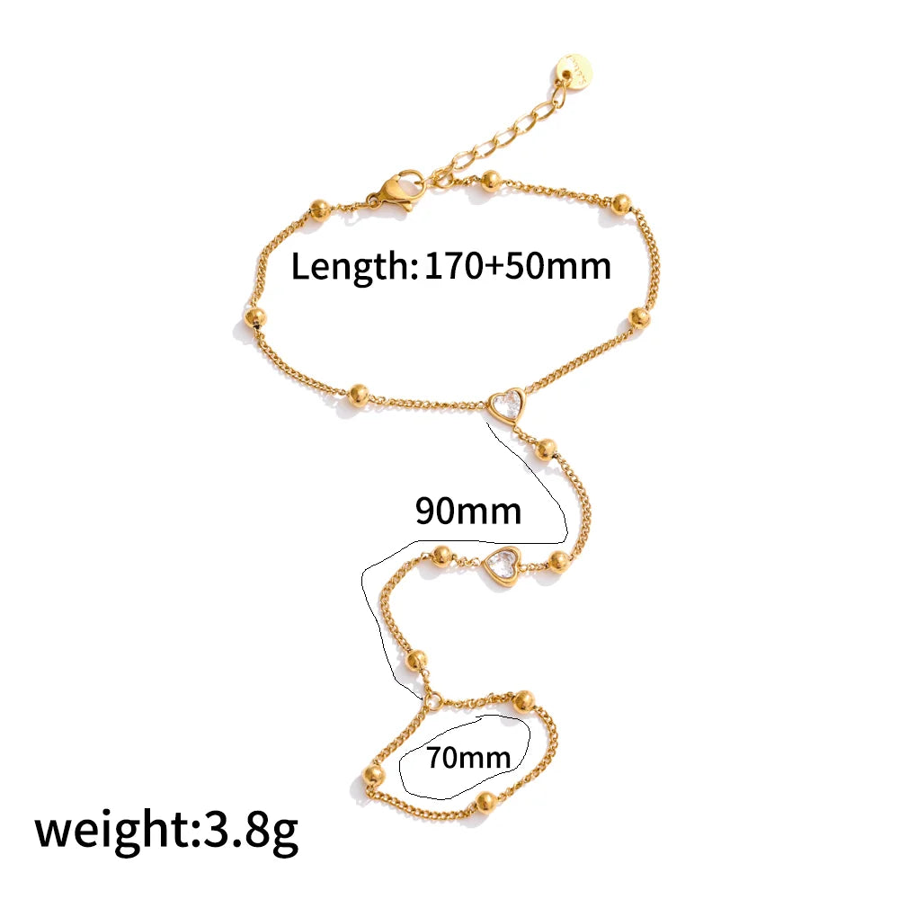 A gold plated stainless steel bracelet featuring a zircon ring design with adjustable length and charms.
