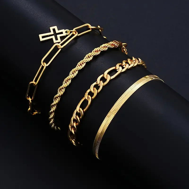 A set of gold-toned stainless steel jewelry including a cross, a chain bracelet, and a thick curb chain bracelet.