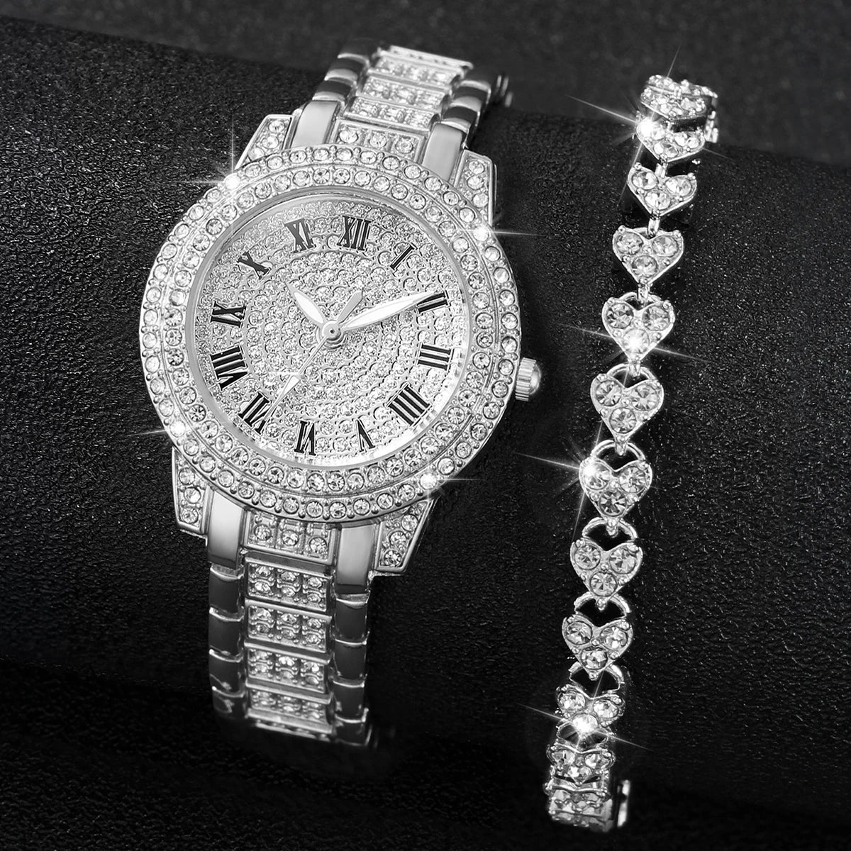 A silver rhinestone heart watch set featuring a round watch and a dangling heart chain.