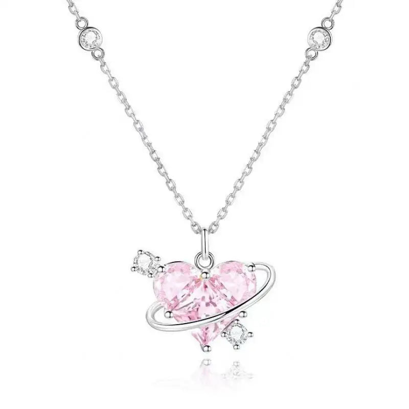 A delicate pink heart necklace featuring zircon stones and a silver chain.