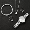 A set of silver diamond rings and a silver quartz wristwatch displayed on a black background.