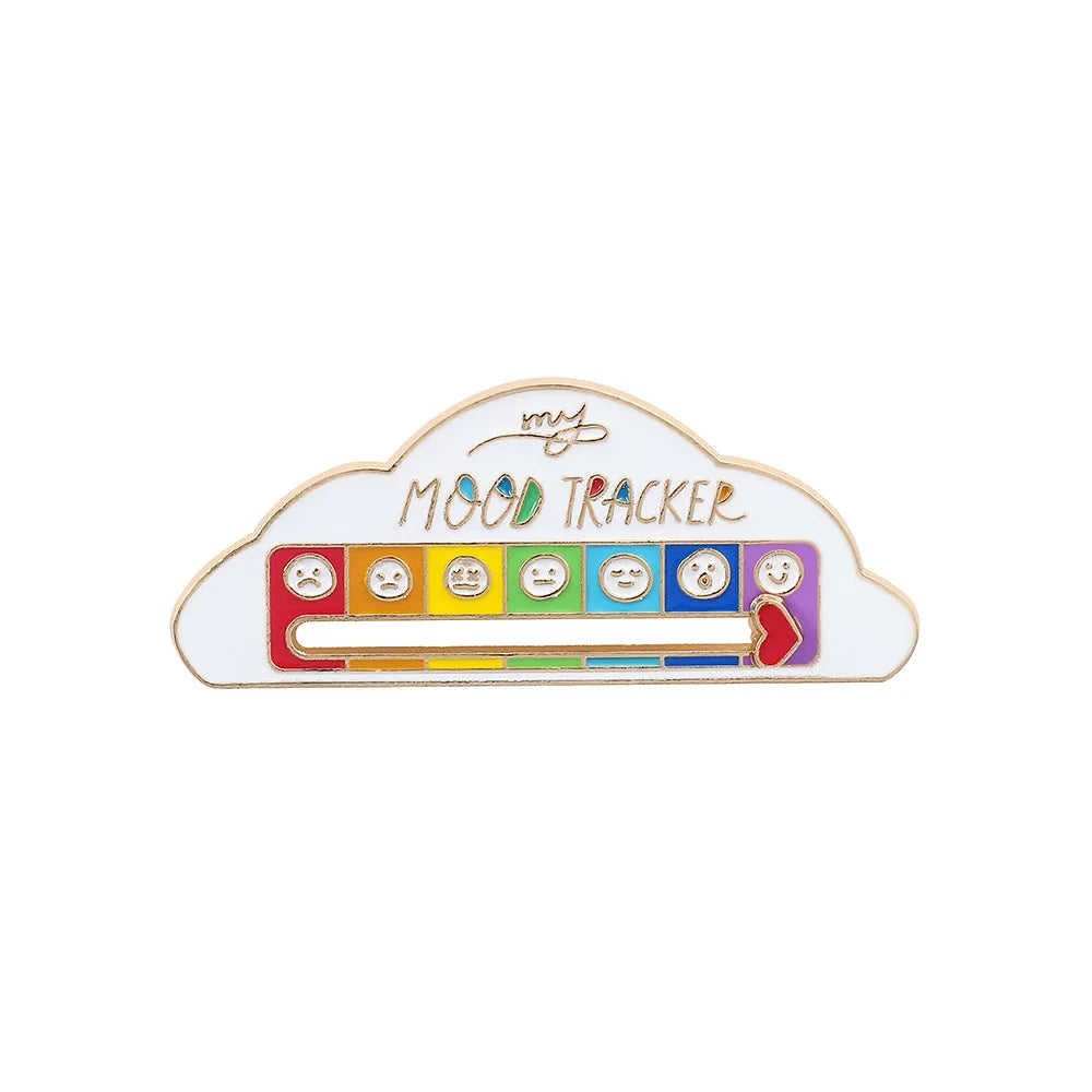 A white enamel brooch pin shaped like a cloud with various facial expressions for mood tracking.