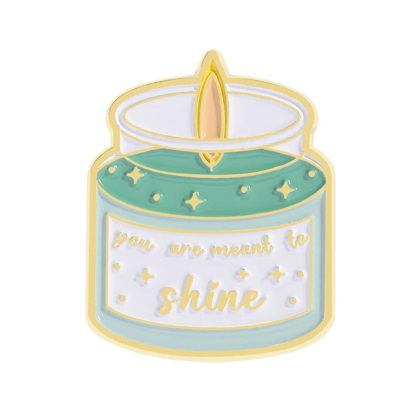 A round enamel pin shaped like a lit candle with the text You are meant to shine on it.