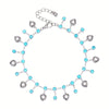 Stainless steel anklet featuring multiple blue rhinestone pendants.