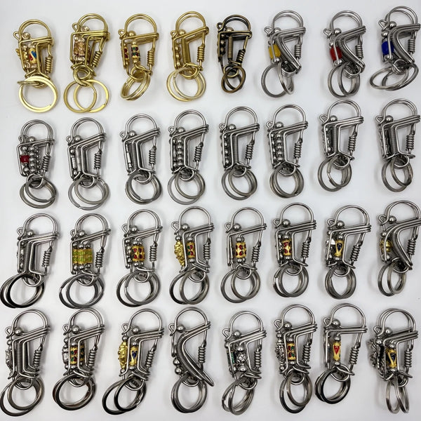 A collection of stainless steel mechanical keychains in various styles and finishes.