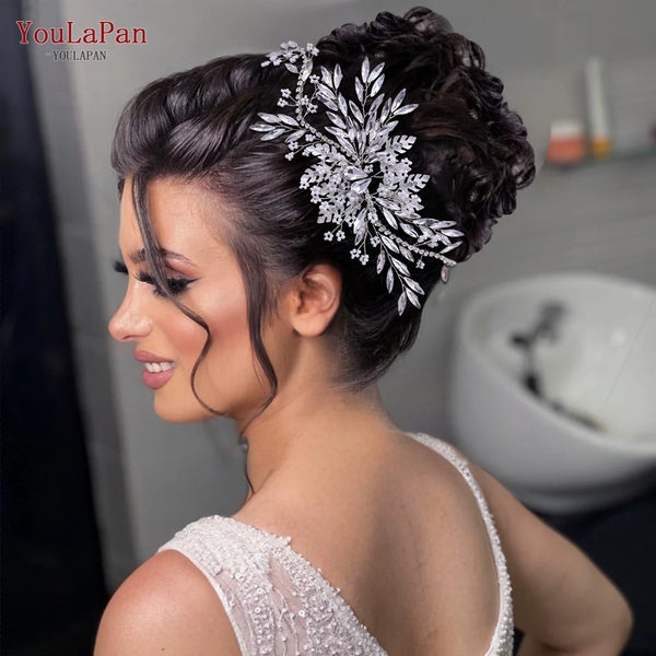 A close-up of a woman wearing a bridal hairstyle adorned with a sparkling rhinestone headband or tiara.