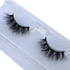 A pair of natural mink false eyelashes displayed in a white plastic tray.