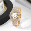 A close-up shot of an elegant gold quartz wristwatch fully encrusted with clear rhinestones on a white surface.