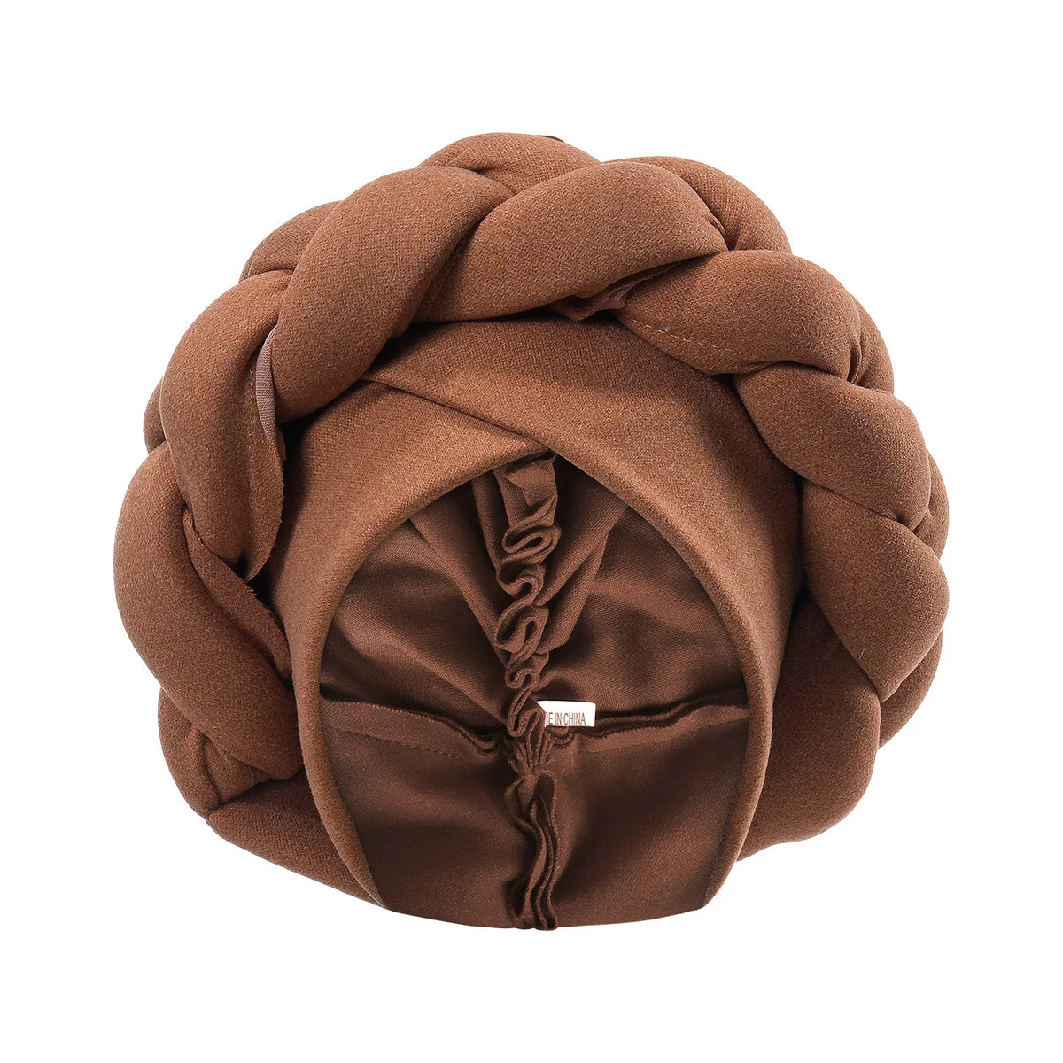 A brown braided turban cap made of fabric is shown in a round shape.