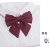 A white shirt with a maroon butterfly ribbon tie set displayed on the collar.