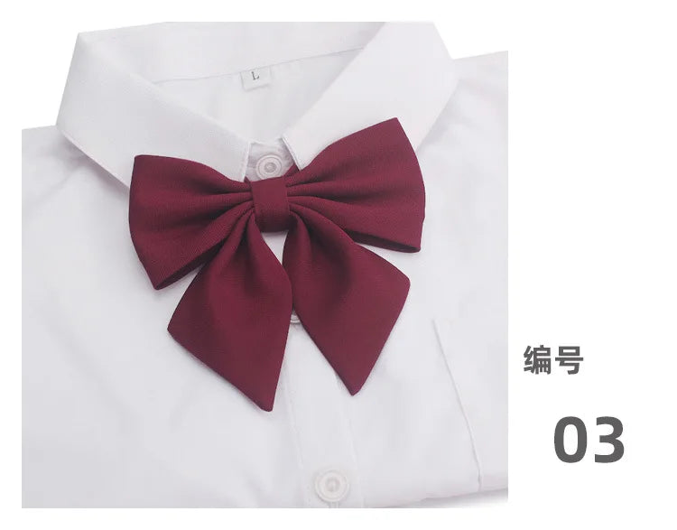 A white shirt with a maroon butterfly ribbon tie set displayed on the collar.