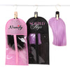 Pink and black wig hair extensions hanging on a wooden holder