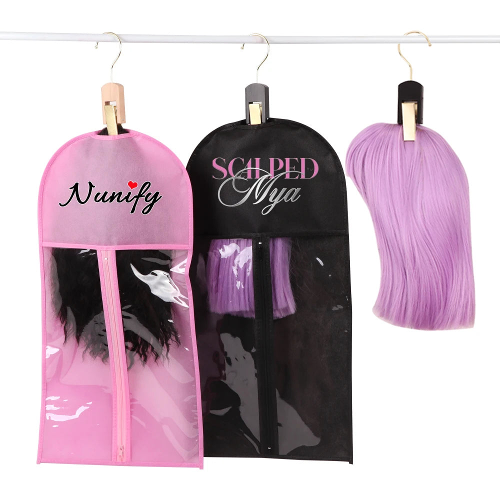 Pink and black wig hair extensions hanging on a wooden holder