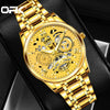 Nahaufnahme einer goldfarbenen Herren-Edelstahluhr mit schwarzem Armband und filigranen Zifferblattdetails.
