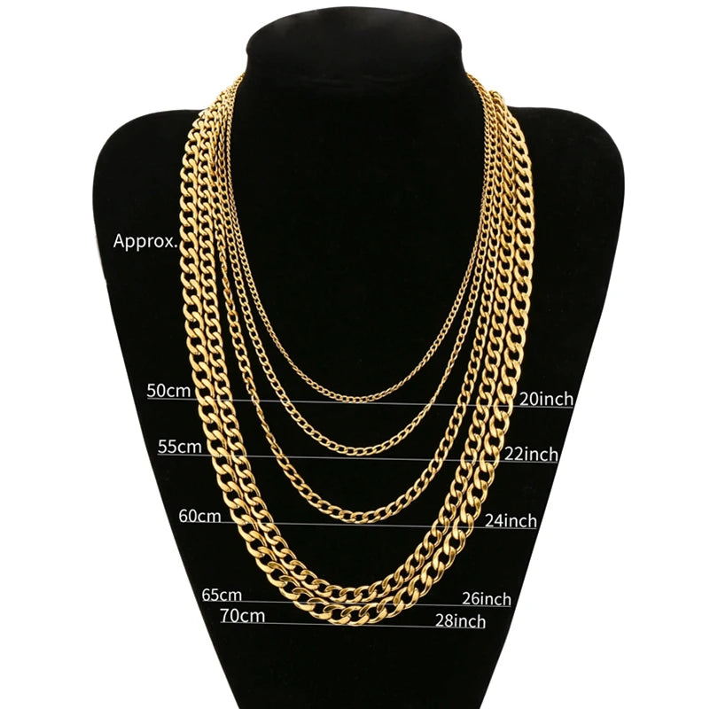 Gold stainless steel Cuban link necklace displayed on a black display stand.