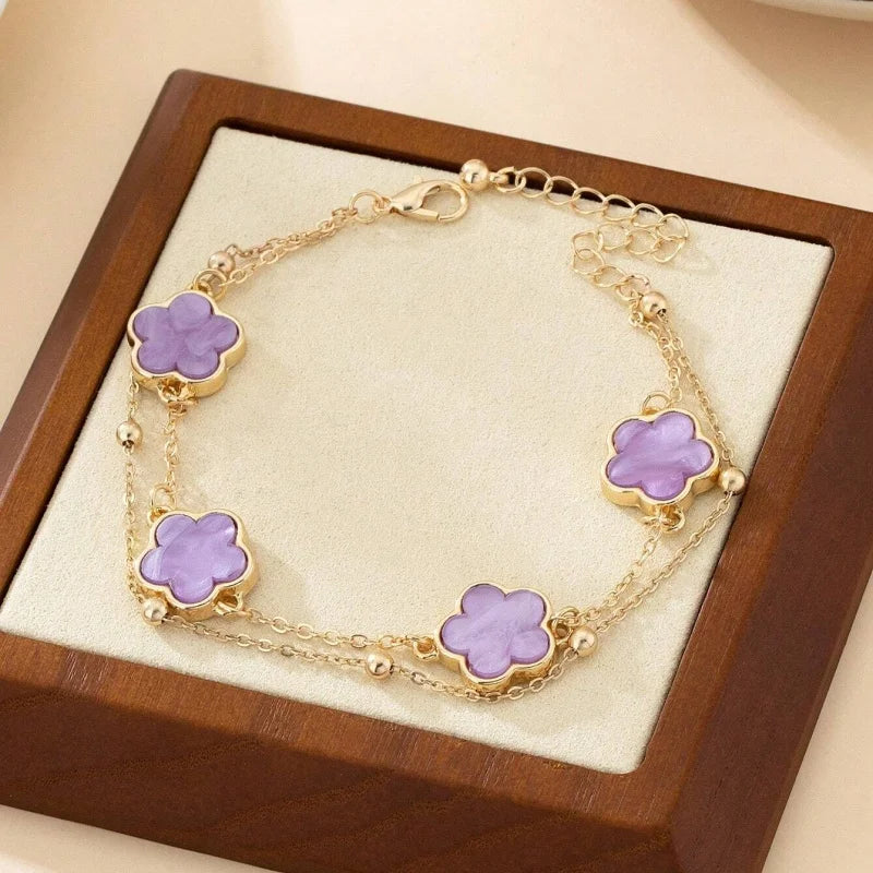 Gold jewelry five-leaf clover anklet displayed in a wooden box