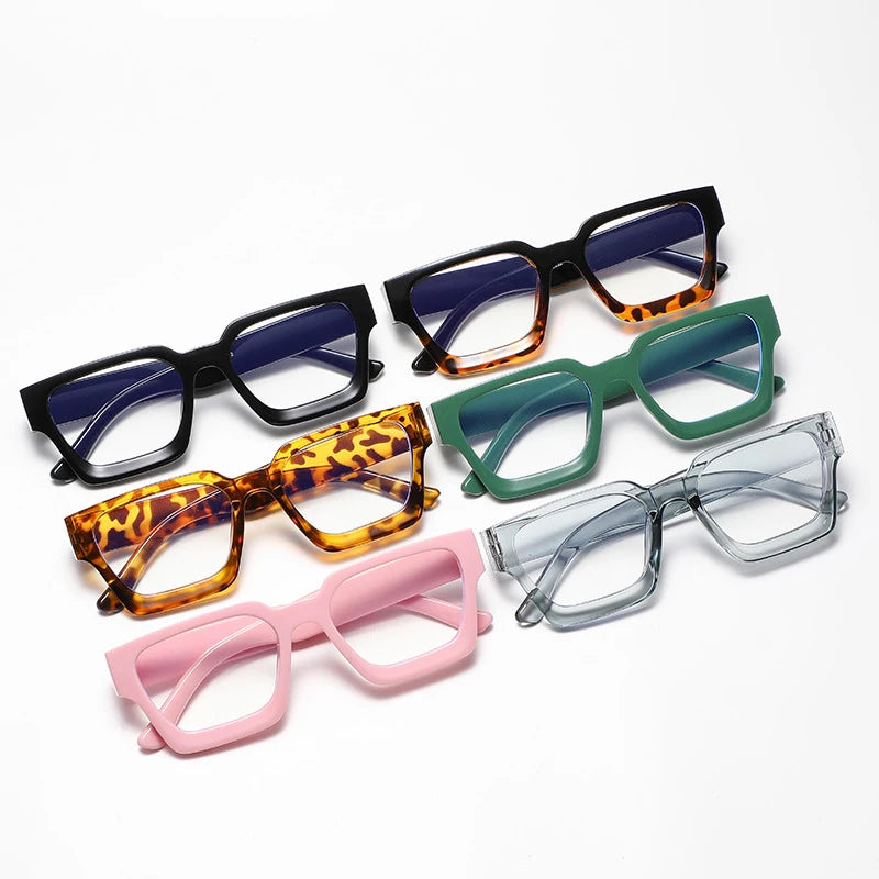 A collection of square anti-blue light computer glasses in various colors including black, orange, green, and pink.
