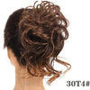 A close-up of messy brown synthetic hair styled in a bun on the back of a person's head.
