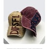 A dark purple velvet embroidered letter baseball cap shown in a studio setting.