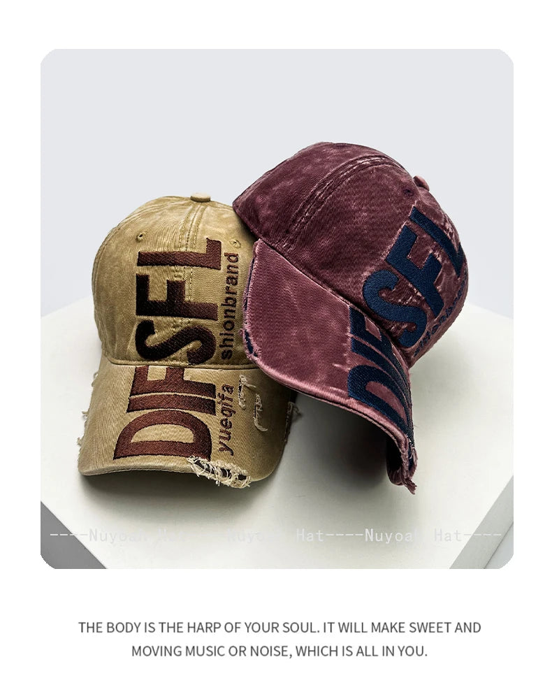 A dark purple velvet embroidered letter baseball cap shown in a studio setting.