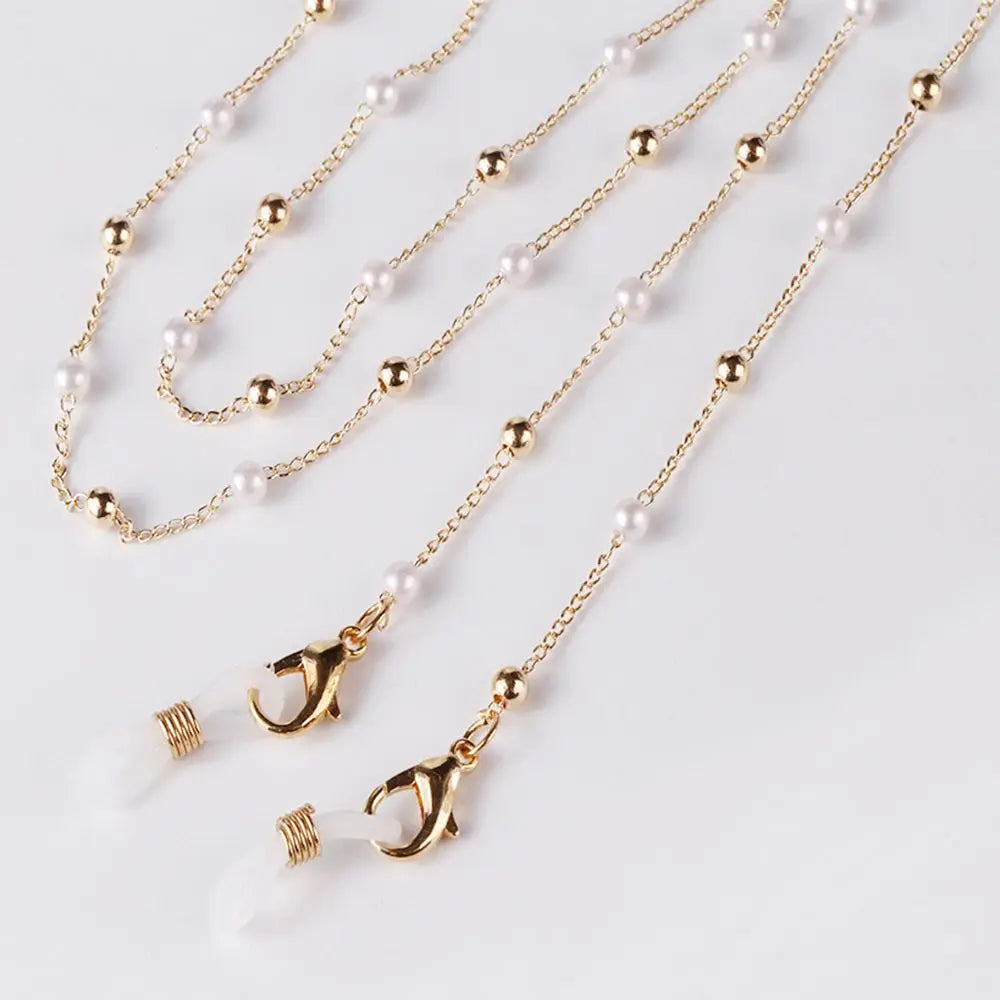 Gold chain lanyard with pearl beads and a gold letter charm