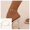 Gold stainless steel snake chain anklet worn on a woman's ankle.