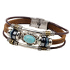 A brown leather bracelet featuring a silver compass design with blue and turquoise stones.