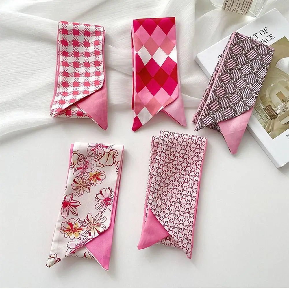 Colección de elegantes diademas y pañuelos de seda rosa con diversos patrones y colores.