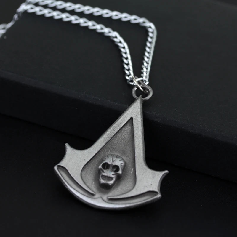 A silver stainless steel pendant necklace shaped like an arrowhead with a skull design.