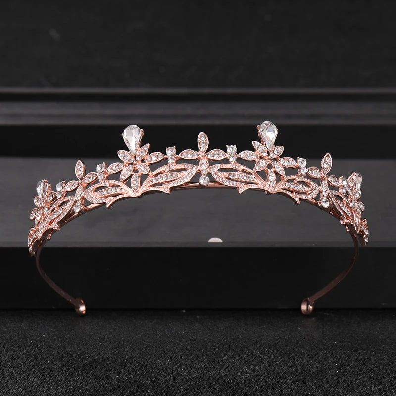 A delicate rose gold bridal tiara headpiece adorned with clear crystals and rhinestones.