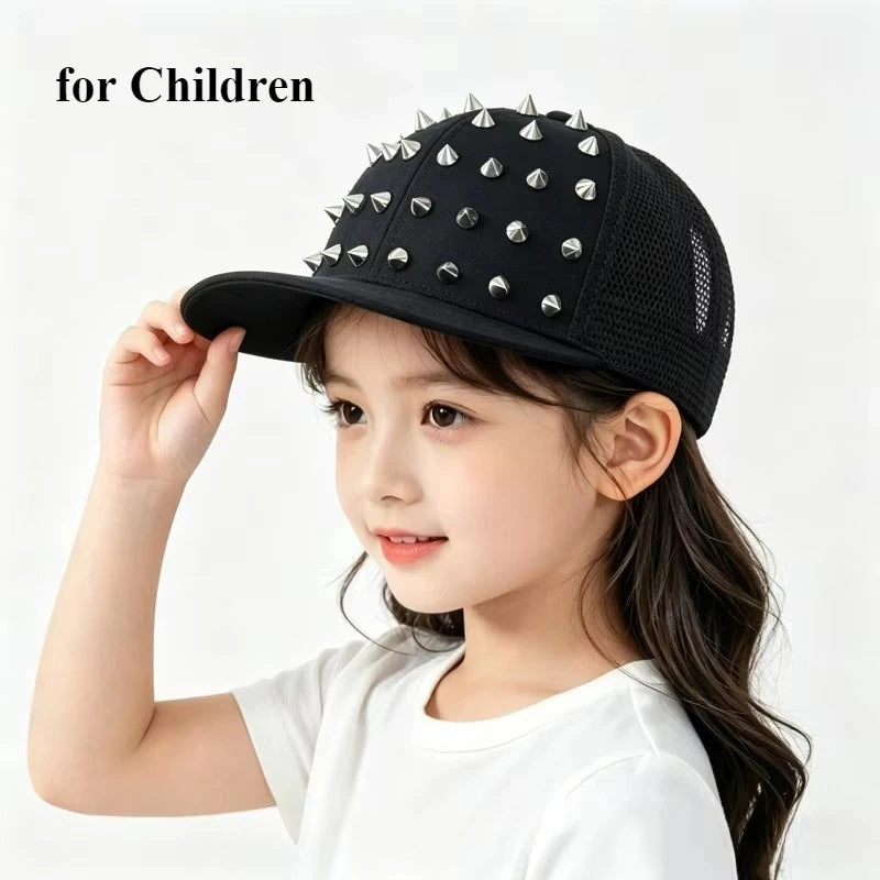 A young girl is holding a black Rivet Flat Hat baseball cap with silver rivets.