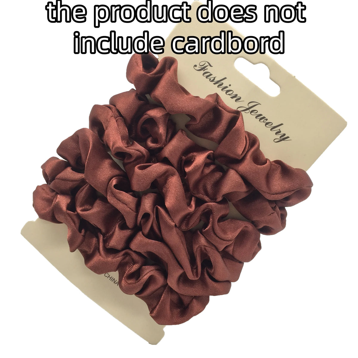 A pile of dark rose satin hair scrunchies is displayed on a cardboard tag.