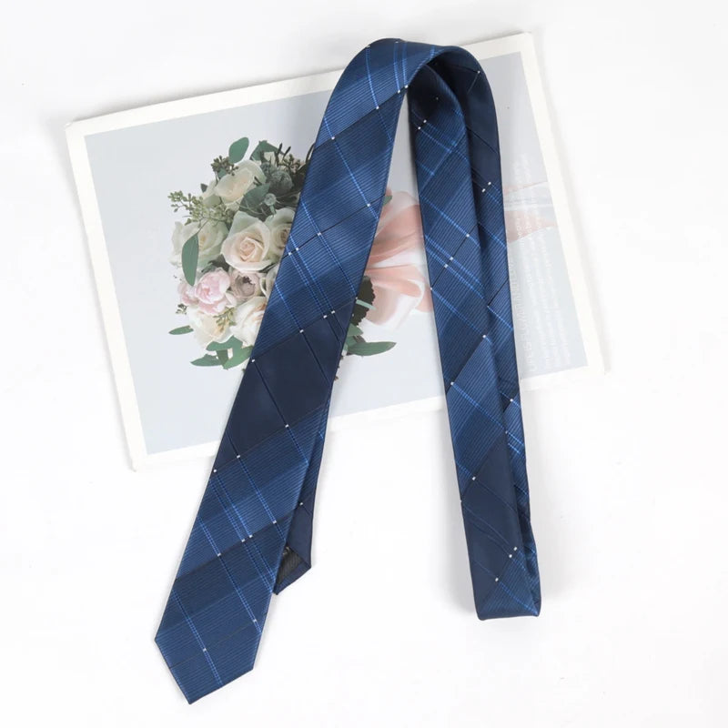 A dark blue plaid skinny necktie with a subtle pattern displayed against a light background.